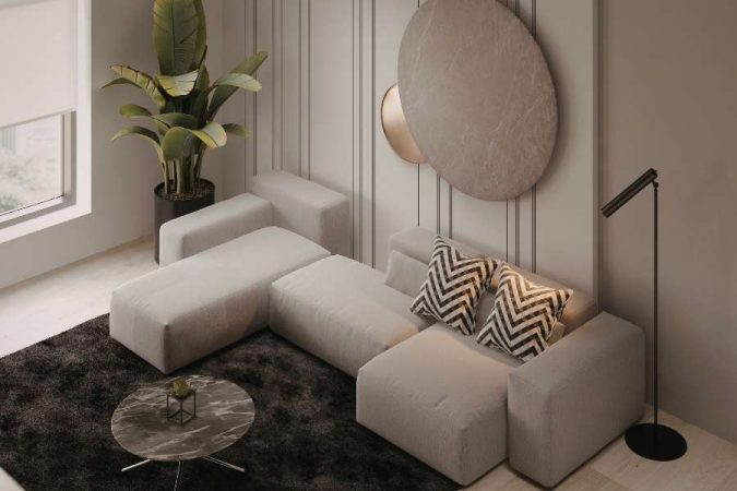 Un canapé d'angle gris clair, exemple de mobilier modulable, est disposé dans un salon moderne.